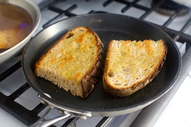 toasting the thick slabs of bread